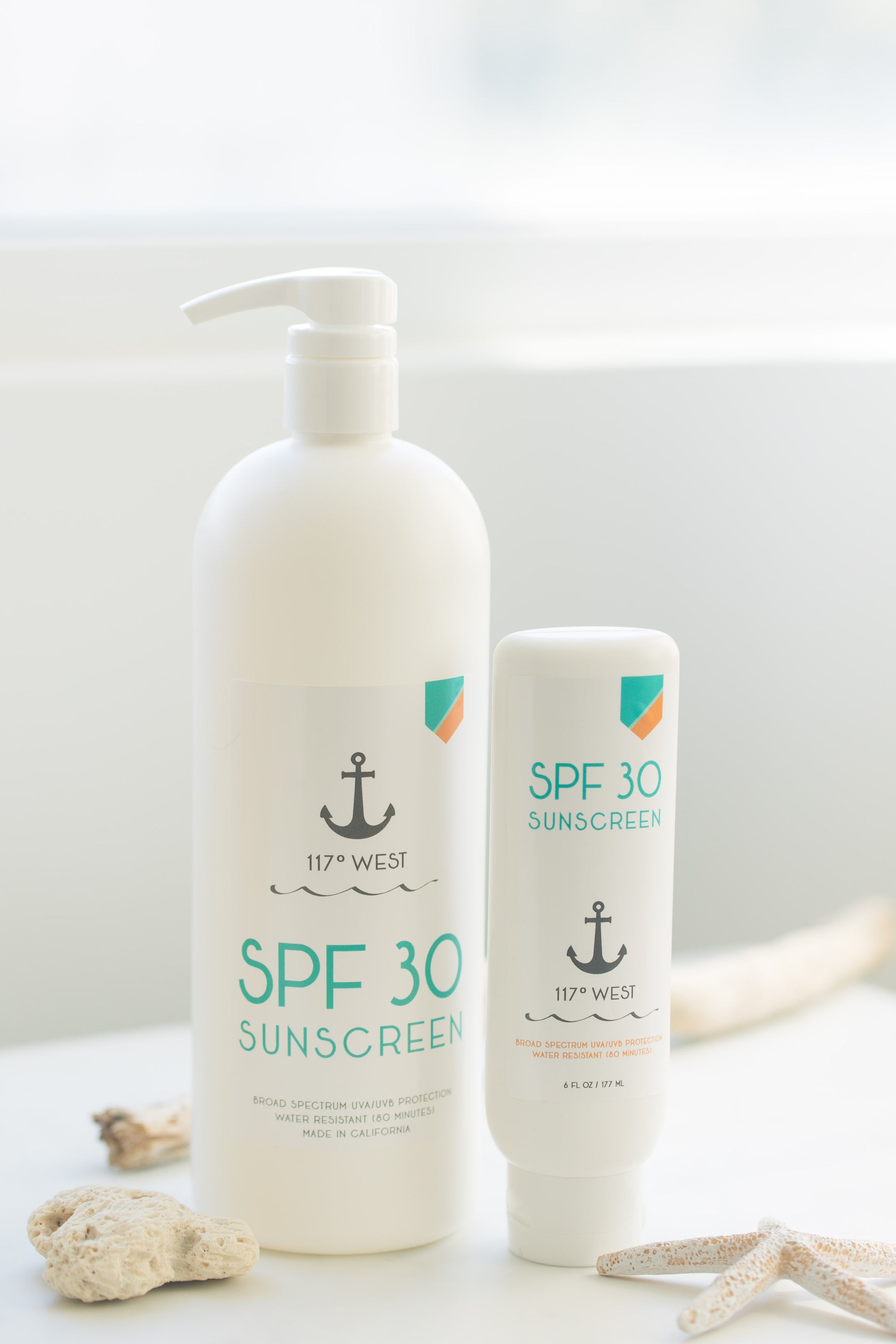 6 oz SPF 30 sunscreen and 32 oz SPF 30 sunscreen on top of a white table
