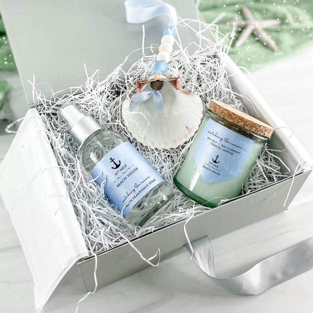 gift box featuring a Beach House Mini Candle, a ﻿Beach House Room Spray﻿ and a matching ﻿Hand-strung Seashell + Glass Decoration