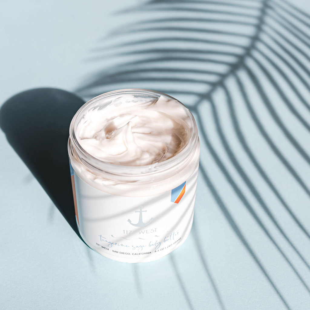 tangerine sage body butter, blue background with leaf shadow