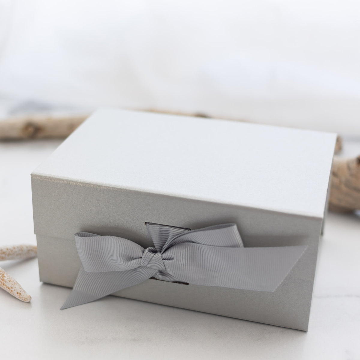 closed gray gift box with a bow