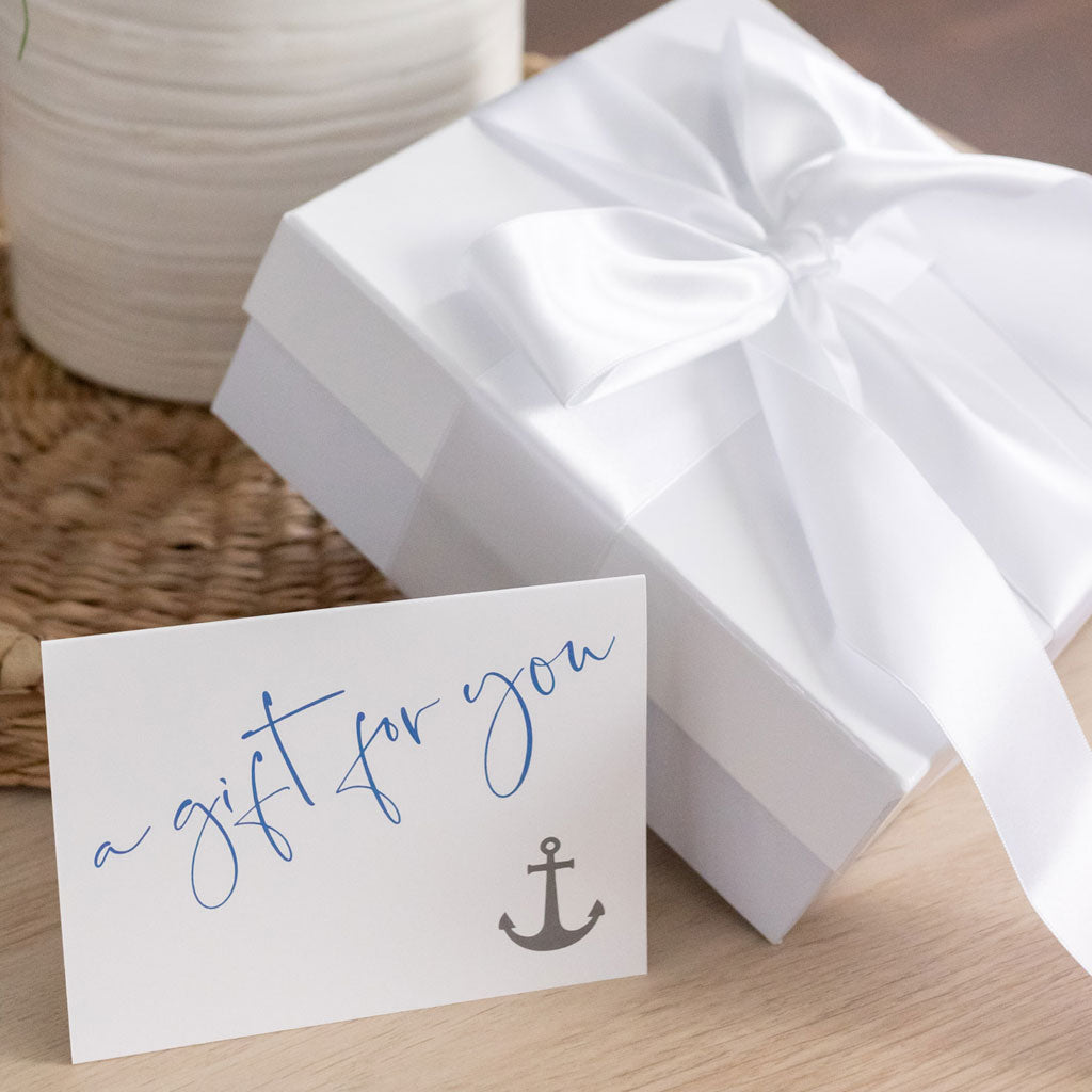 gift box & wrapping with card on wooden table