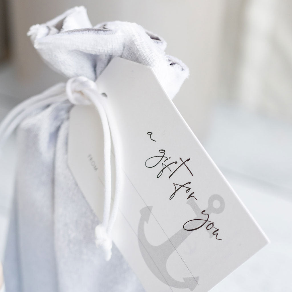 silver gaft bag with a custom gift tag attached